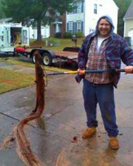 Tree root removed from a sewer line during a winter storm